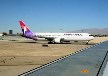 A Hawaiian Airlines jet taxies out to th